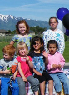 Children in foster care on top of a parade float
